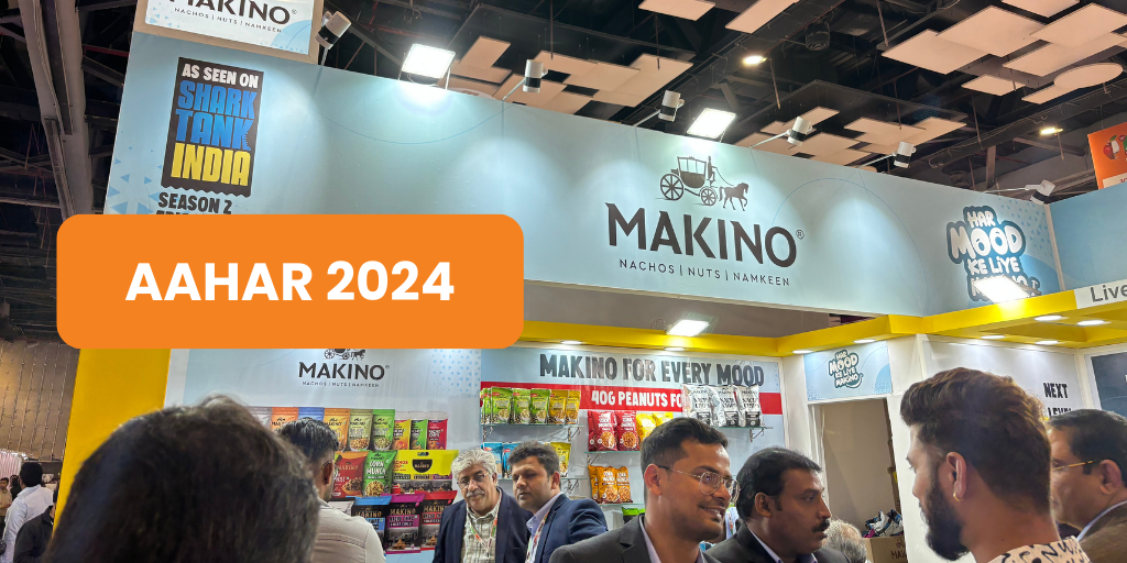 AAHAR 2024: Crowded trade show booth with Makino snacks display.