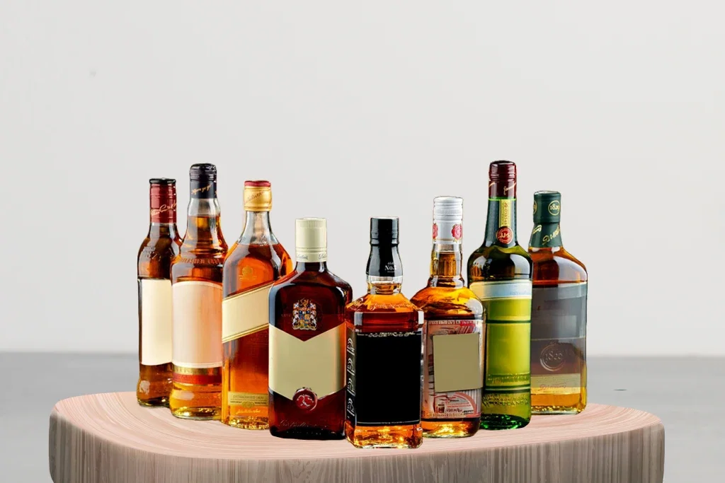 Liquor brand bottles on wooden surface.