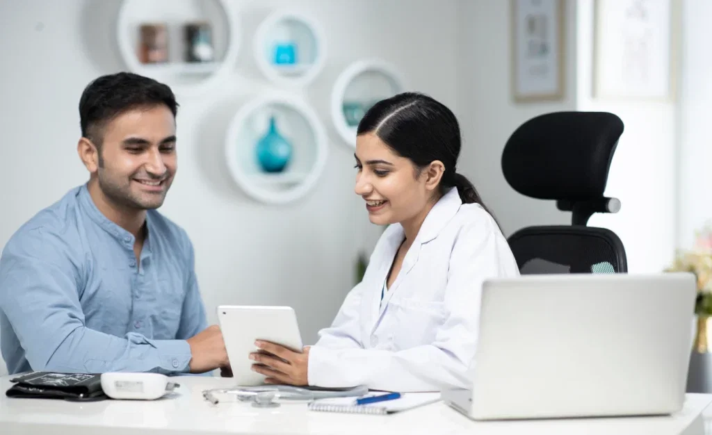 Pharma SFA software on tablet; doctor and patient consultation.