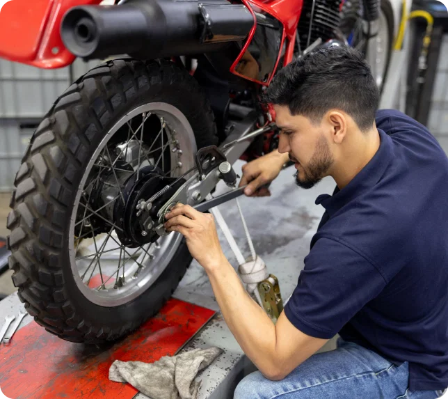 Mechanic repairing motorcycle brake, SFA software.